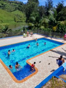 a group of people in a swimming pool at HOTEL EL POTRILLO in El Peñol