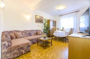 a living room with a couch and a table at Apartment in Rovinj/Istrien 11533 in Rovinj