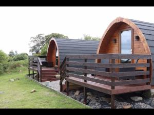 a couple of benches sitting outside of a building at Breakish Bay Pods (Pod 2) in Breakish