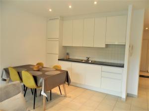a kitchen and dining room with a table and chairs at O ZEE app,garage 200m van strand en centrum in Koksijde