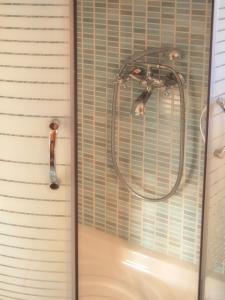 a shower with a glass door with a shower head at Eligia Villas in Mixórrouma