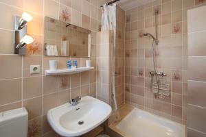 a bathroom with a sink and a toilet and a shower at Aparthotel Klara in Timmendorfer Strand +63 photos