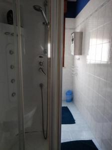 a shower in a bathroom with a blue rug at Civico 26 in Treviso +74 photos