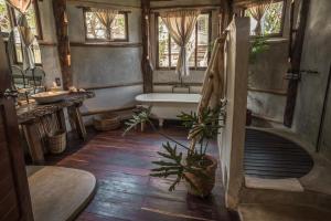 a bathroom with a bath tub and a sink at Delek Tulum in Tulum +37 photos