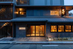 a building with its doors open on a street at Hotel Wing International Premium Kyoto Sanjo in Kyoto