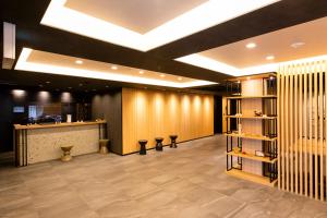 a lobby with a bar and a counter with stools at Hotel Wing International Premium Kyoto Sanjo in Kyoto