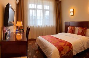 Postel nebo postele na pokoji v ubytování King Parkview Hotel
