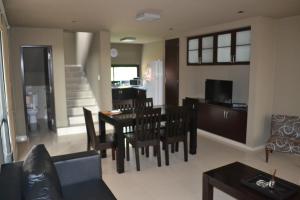 a living room with a table and a dining room at La Wet in Tartagal
