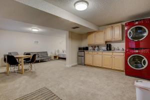 a living room with a kitchen and a table with chairs at Bright & Cozy Studio Apartment in Colorado Springs in Colorado Springs