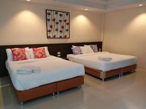 Ein Bett oder Betten in einem Zimmer der Unterkunft Sand Paisan Resort