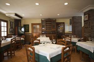 a restaurant with tables and chairs with wine glasses at Hostal El Labrador in Marbella