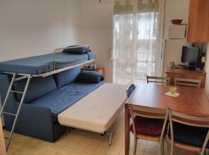 a small room with a bunk bed and a table at Mare Pineta 2 in Lido di Volano