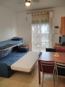 a room with a bed and a table and a dining room at Mare Pineta 2 in Lido di Volano