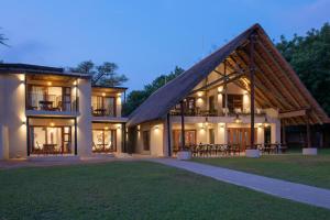a large house with a gambrel roof at Buckler's Africa Lodge Kruger Park in Komatipoort