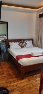 a bedroom with a large bed with a fan at A Place to Remember El Nido in El Nido