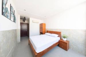 Postel nebo postele na pokoji v ubytování SaiGon CoZy Hotel "241 Pham Ngu Lao Street''