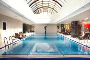 a large swimming pool in a building with a ceiling at Novotel Ambassador Seoul Gangnam in Seoul