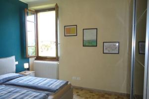 a bedroom with a bed and a window at Il Vaticano del lago d Idro in Crone