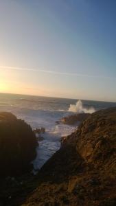 a view of the ocean from a rocky shoreline at Le Churchill Hôtel & Spa in Carnac