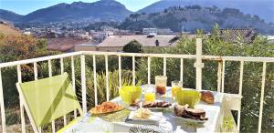 a table with bread and drinks on a balcony at Coste Location Cassis in Cassis