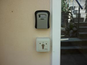 a pay phone on the side of a house at Villa du soleil levant in Apt