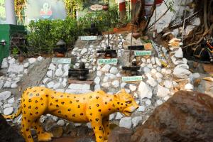 a statue of a dalmatian dog in a garden at Pali Village Resort in Mire