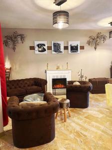 a living room with two couches and a fireplace at Hostellerie Saint Benoît in Aniane