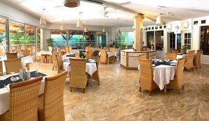 a dining room with tables and chairs in a restaurant at Hostellerie Saint Benoît in Aniane
