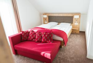 a bedroom with a bed and a couch at Hotel Waldeck mit Restaurant "Florian'S" in Feldberg