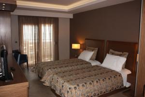 Posteľ alebo postele v izbe v ubytovaní Hotel Cariatis