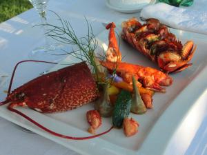 a plate of food with seafood on a table at Le Parasol in Ars-en-Ré