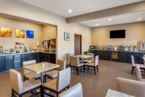 a restaurant with tables and chairs and a bar at Comfort Inn Evanston I-80 in Evanston