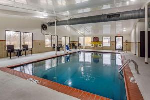 a large swimming pool with blue water in a building at Comfort Inn Paducah I-24 in Paducah