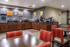 a restaurant with a counter and tables and chairs at Comfort Inn Paducah I-24 in Paducah