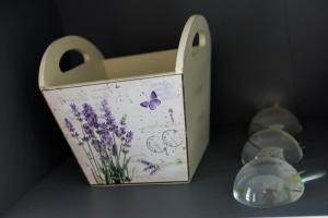a wooden box with a picture of a butterfly and flowers at Apartments Ammos in Saplunara