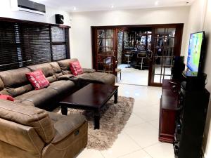 a living room with a couch and a tv at C&C HOTEL VIBES Randpark Ridge JHB 14 Units Available in Boskruin
