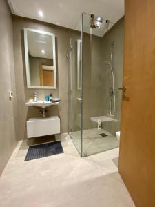 a bathroom with a shower and a sink at MARINA - ROYAL PENTHOUSE by Appart’Ali in Casablanca