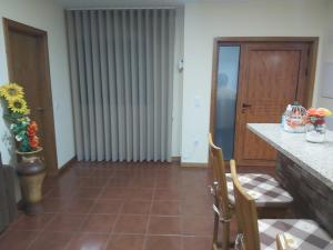 a kitchen with a counter and a table and chairs at Casa da Tia Bina in Castelo de Paiva +56 photos