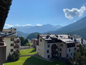 an aerial view of a building with mountains in the background at Bilocale nuovo St. Moritz Chesa Arlas in St. Moritz