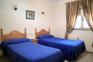 Postel nebo postele na pokoji v ubytování Hostal Delfin Verde