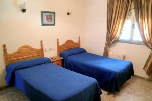 Postel nebo postele na pokoji v ubytování Hostal Delfin Verde