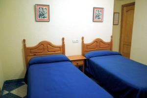 Postel nebo postele na pokoji v ubytování Hostal Delfin Verde