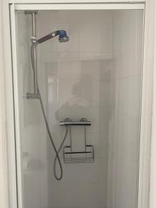 a shower with a shower head in a bathroom at The Old Brasserie & Rooms @ no.8 in Dartmouth