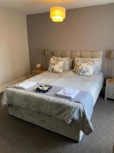 a bedroom with a large bed with two books on it at The Old Brasserie & Rooms @ no.8 in Dartmouth