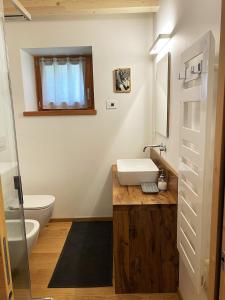 a bathroom with a sink and a toilet at B & B Chalet Plan in Strembo