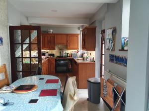 a kitchen with a table and a kitchen with wooden cabinets at Eltham-Lee in Eltham