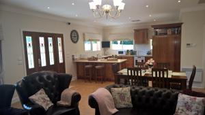 a living room and kitchen with a table and chairs at Cleggett Estate Holiday Cottage in Gisborne