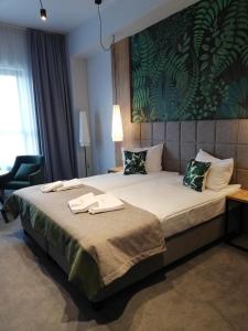 Ein Bett oder Betten in einem Zimmer der Unterkunft FOLGA - Hotel, Restauracja, Browar, SPA
