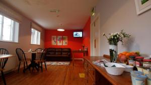 a living room with a couch and a table at Climbers Inn in Glencar