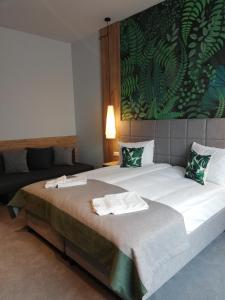 Ein Bett oder Betten in einem Zimmer der Unterkunft FOLGA - Hotel, Restauracja, Browar, SPA